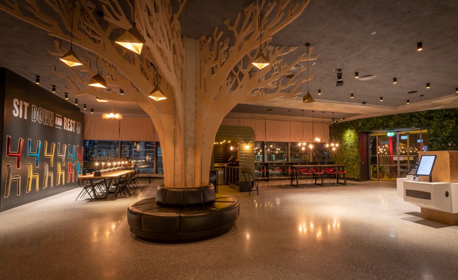 Wooden tree sculpture and lights in hotel lobby