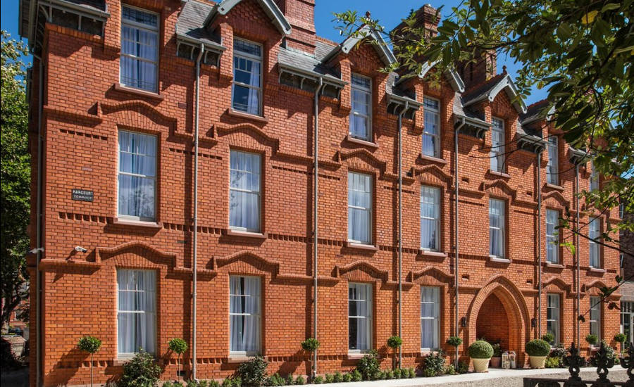 Red-brick exterior of the Wilder Townhouse on a sunny day