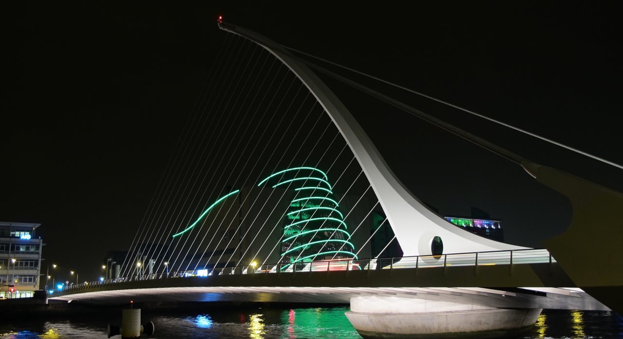 Samuel Beckett Bridge illuminated in green