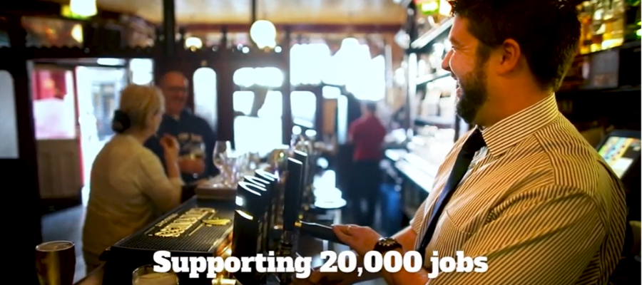 Man pulling a pint in a pub with text underneath that reads "Supporting 20,000 jobs" 