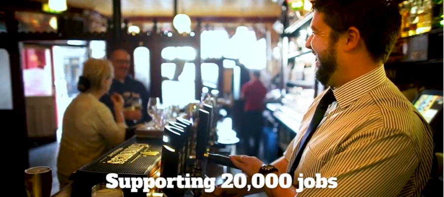 Man pulling a pint in a pub with text underneath that reads "Supporting 20,000 jobs"