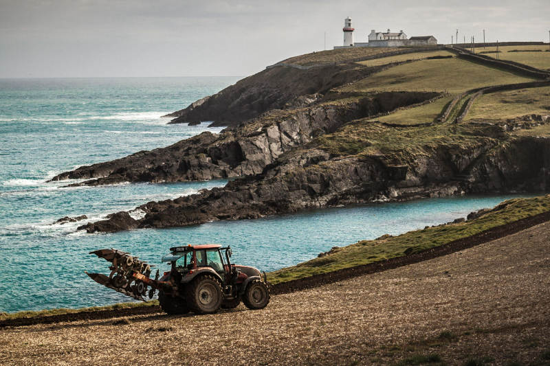 A stark outcropping of rocks in a rough but brilliant blue seain clonakilty cork.