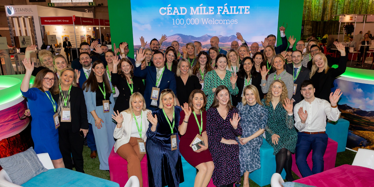 Large group of people posing in front a Meet in Ireland backdrop