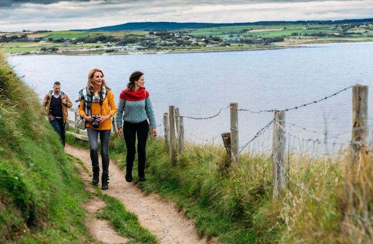 People walking along the cliffs at Ardmore