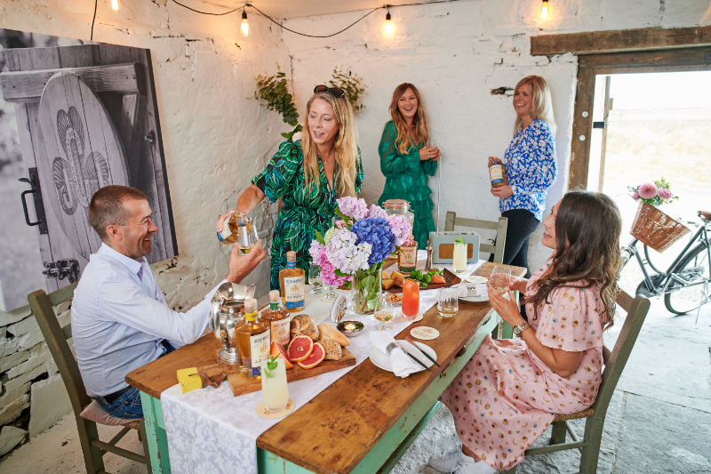 A photograph of people enjoying a meal and whiskey at JJ Corey Whiskey Experience Co. Clare