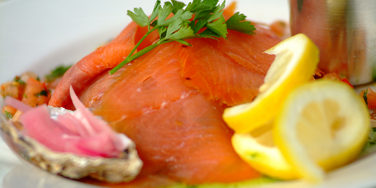 Beautiful plate of food, smoked salmon with fresh parsely and lemons