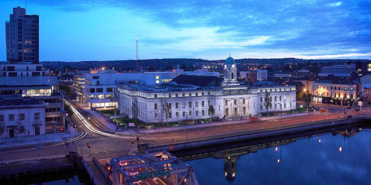 Landscape image of Cork City Hall at dusk
