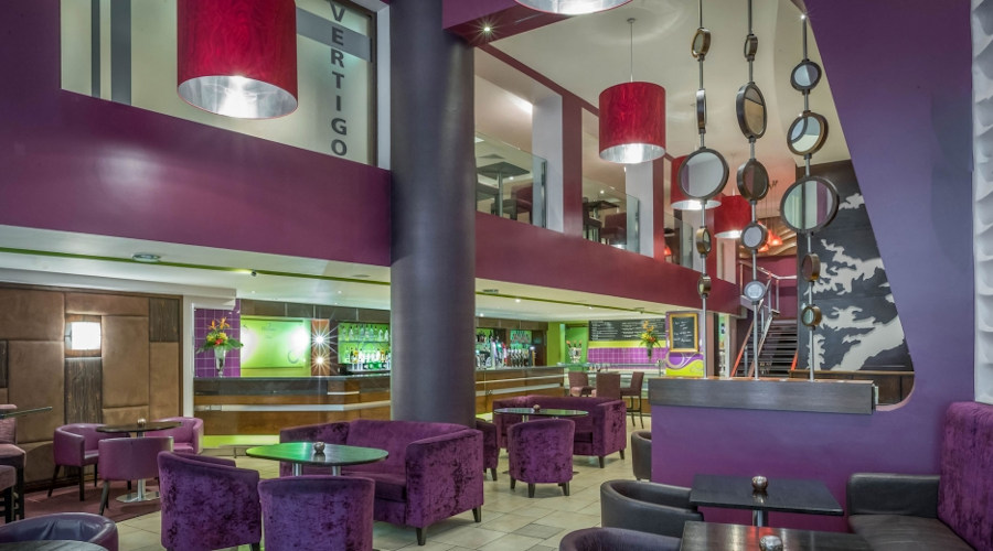 Modern purple and red decor of Clayon Hotel bar