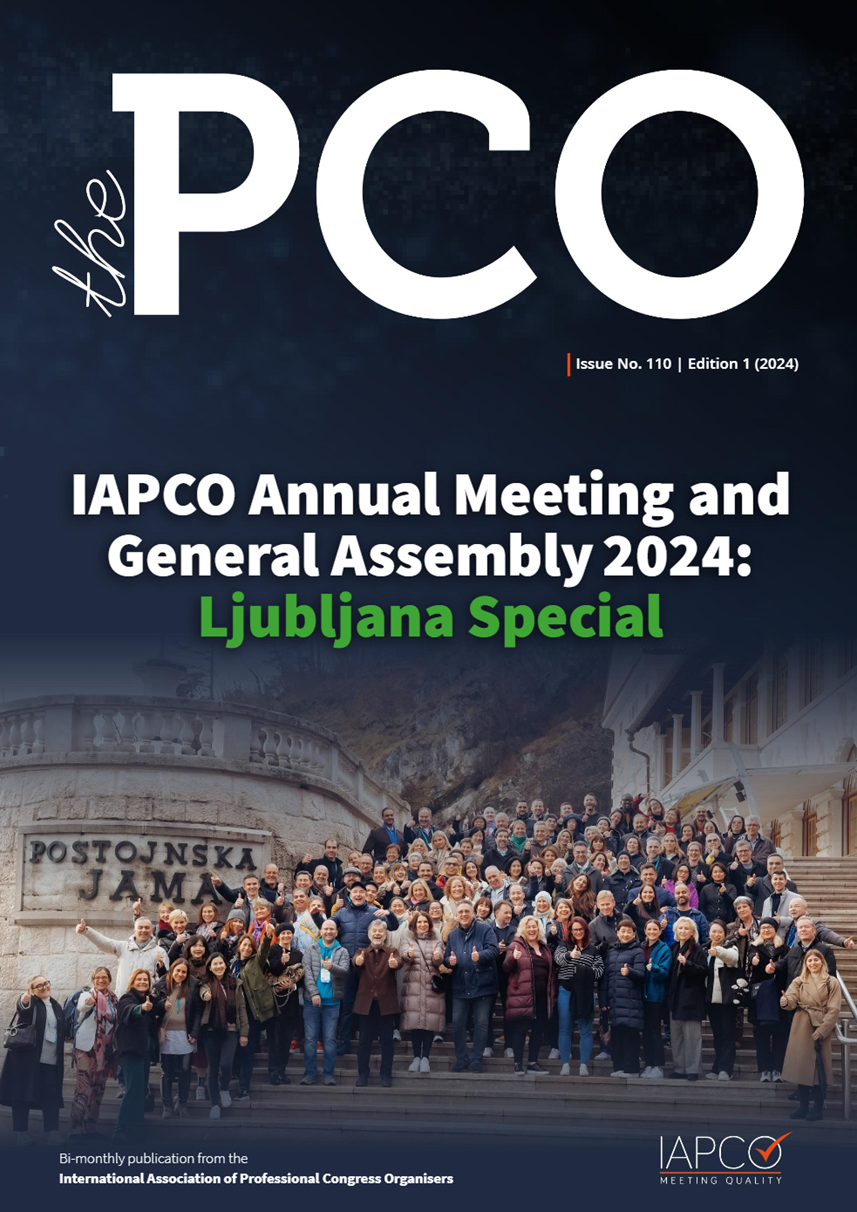 Cover of 'The PCO' magazine, featuring the IAPCO Annual Meeting and General Assembly 2024: Ljubljana Special, with a large group photo taken in front of Postojnska Jama cave