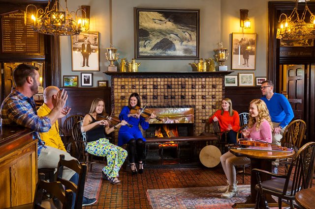 Musicians play traditional Irish instruments in an authentic Irish pub