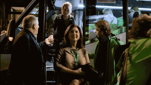 Passengers getting off a bus and thanking the driver