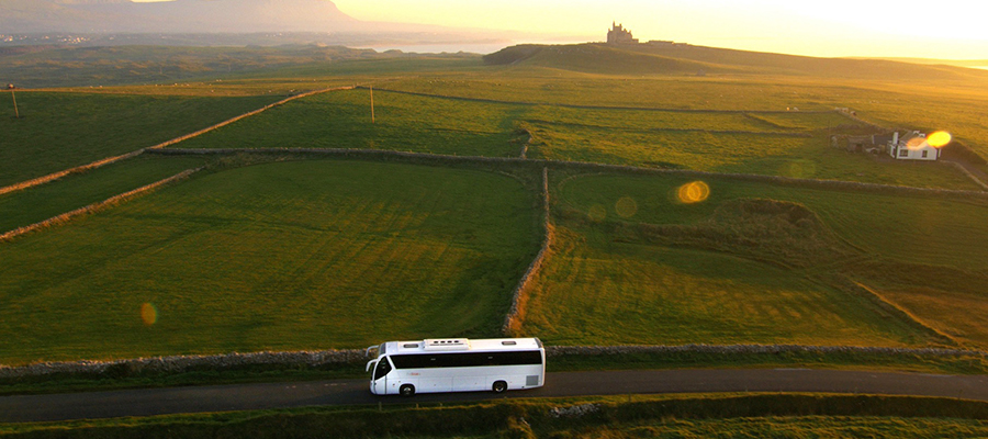 Bus crossing the Mullaghmore Peninsula in County Sligo with Classiebawn Castle in the background