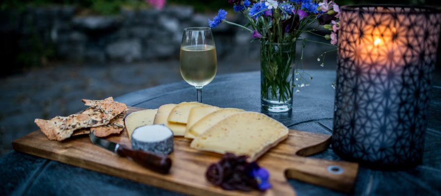 A candlelit spread of cheese and wine